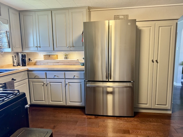 kitchen with freestanding refrigerator, light countertops, dark wood-style floors, and gray cabinets