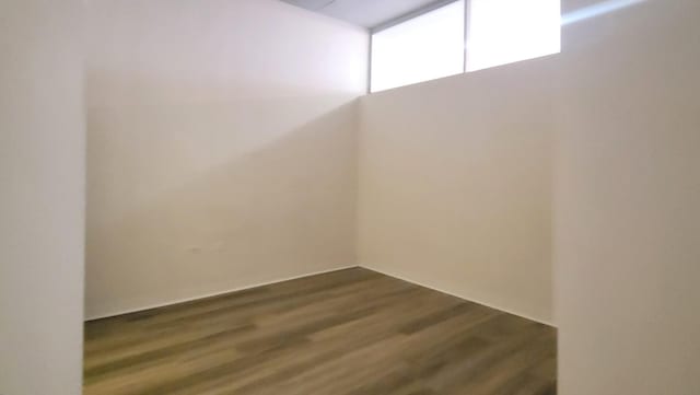 empty room with dark wood finished floors