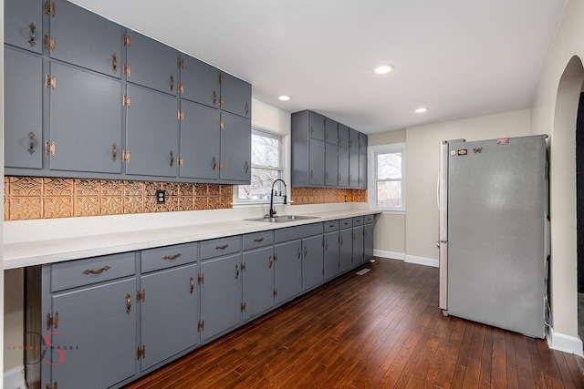 161 S Cash St, Seneca, IL 61360 - kitchen with light countertops, dark wood-type flooring, baseboards, a sink, and freestanding refrigerator