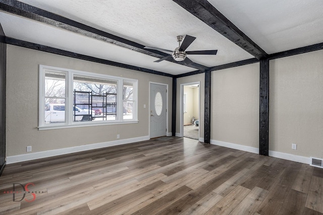 161 S Cash St, Seneca, IL 61360 - unfurnished living room with baseboards, a textured ceiling, wood finished floors, and beam ceiling