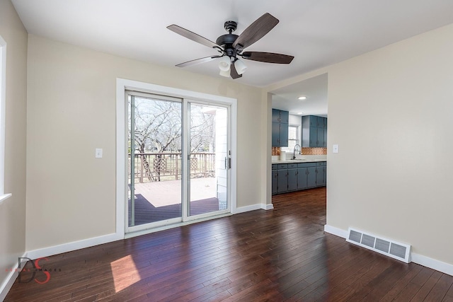 161 S Cash St, Seneca, IL 61360 - unfurnished living room with baseboards, visible vents, and dark wood-style flooring