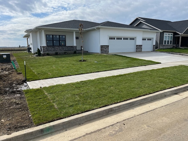2477 Stanfield Ln, Normal, IL 61761 - view of front of house with an attached garage, driveway, a front yard, and stone siding