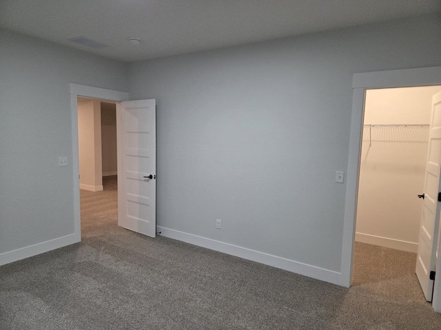 2477 Stanfield Ln, Normal, IL 61761 - unfurnished bedroom featuring baseboards, a spacious closet, and carpet floors