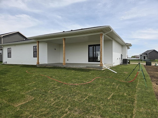 2477 Stanfield Ln, Normal, IL 61761 - rear view of property with a lawn, a patio, and central AC unit