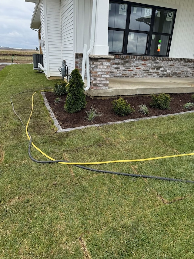 2477 Stanfield Ln, Normal, IL 61761 - exterior details with brick siding, central AC unit, board and batten siding, and gas meter