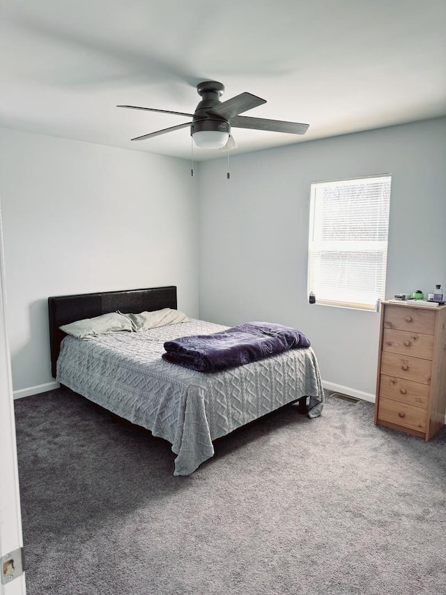 bedroom featuring baseboards, carpet floors, and a ceiling fan