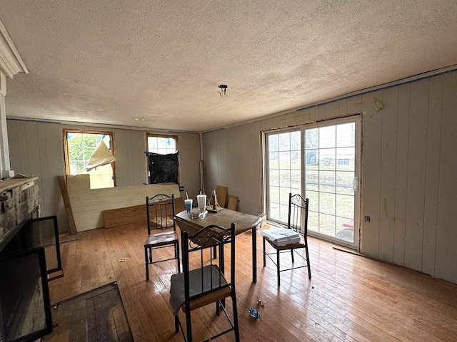 dining room featuring hardwood / wood-style floors and a textured ceiling