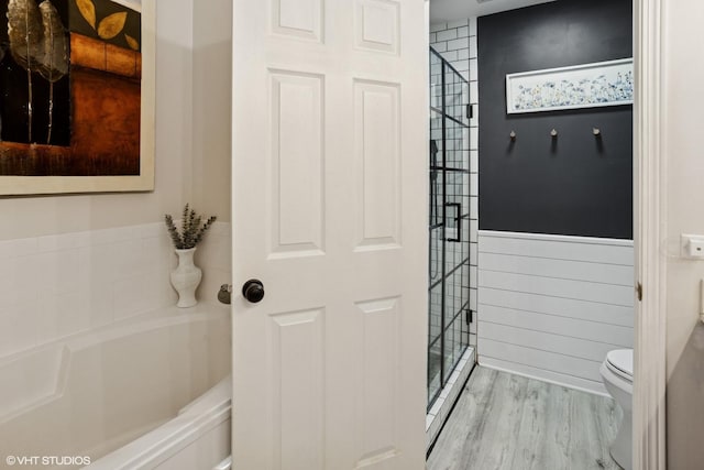 639 Concord Way, Prospect Heights, IL 60070 - bathroom with a shower stall, wood finished floors, a bath, a wainscoted wall, and toilet