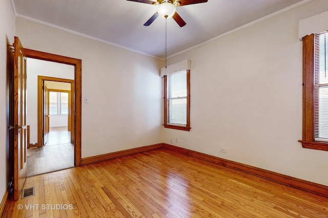 3028 N Kostner Ave, Chicago, IL 60641 - spare room featuring light wood-type flooring, ornamental molding, baseboards, ceiling fan, and visible vents