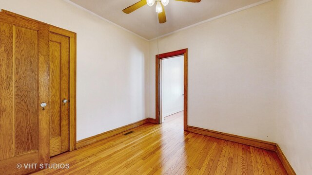 3028 N Kostner Ave, Chicago, IL 60641 - empty room with crown molding, baseboards, light wood-style flooring, and a ceiling fan