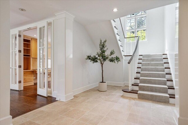 stairs featuring baseboards, recessed lighting, and french doors