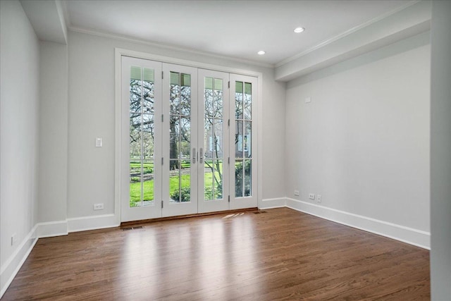 empty room with visible vents, ornamental molding, baseboards, dark wood-style floors, and recessed lighting