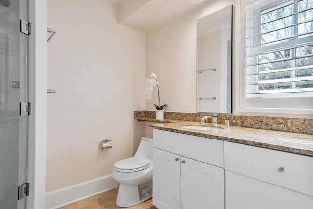 bathroom featuring baseboards, plenty of natural light, a stall shower, and toilet