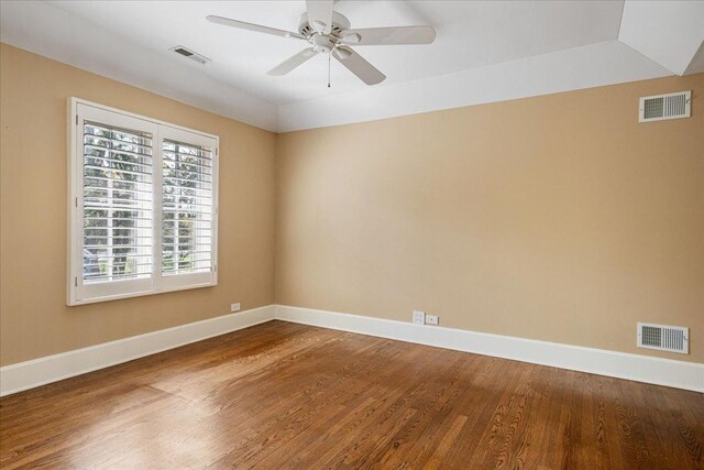 spare room with visible vents and wood finished floors