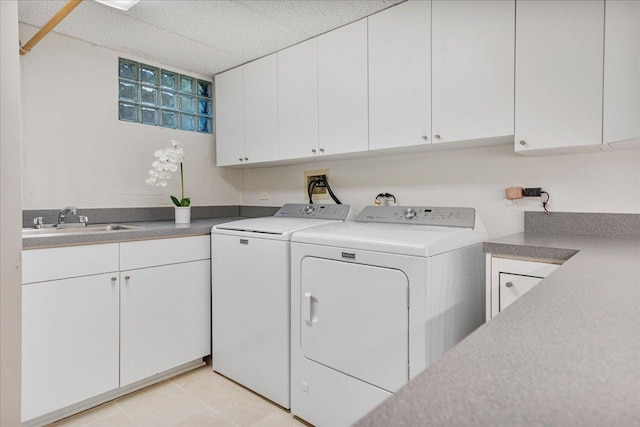 clothes washing area with separate washer and dryer, a sink, cabinet space, and light tile patterned floors