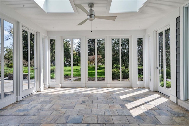 unfurnished sunroom with french doors, plenty of natural light, and a skylight