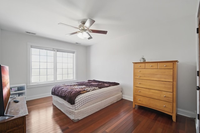 bedroom with dark wood-style floors, visible vents, ceiling fan, and baseboards