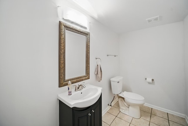 half bath with toilet, vanity, tile patterned flooring, baseboards, and visible vents