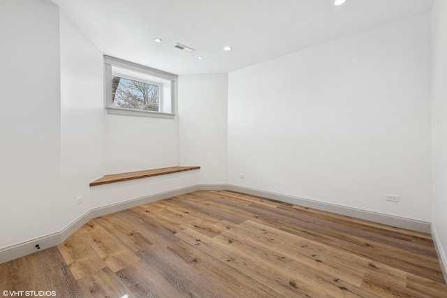 spare room featuring visible vents, wood finished floors, baseboards, and recessed lighting