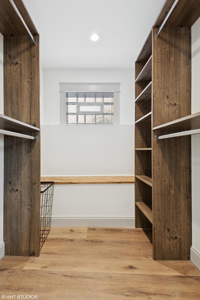 walk in closet featuring wood finished floors
