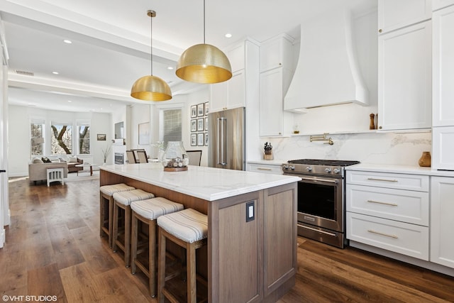 kitchen with premium range hood, a center island, stainless steel appliances, and recessed lighting