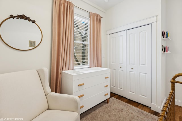 sitting room with dark wood-style floors and a healthy amount of sunlight
