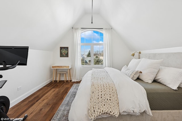 bedroom featuring baseboards, wood finished floors, and lofted ceiling