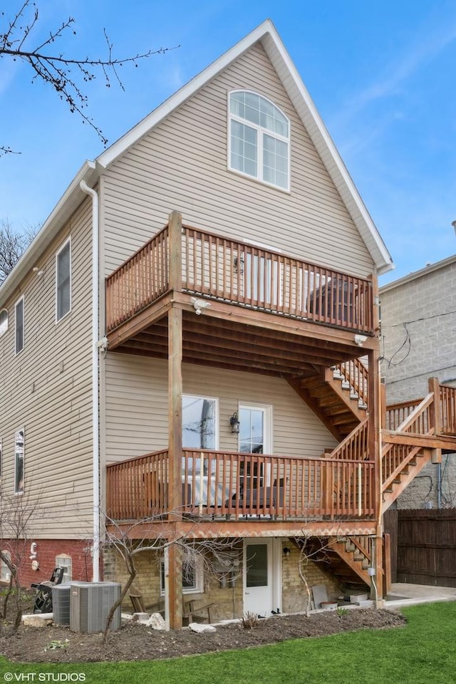 rear view of property with central air condition unit, stairs, a deck, and fence