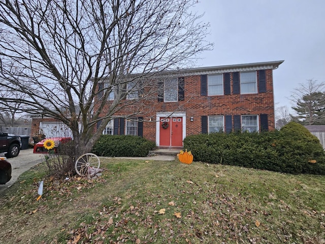 colonial house featuring brick siding and a front lawn