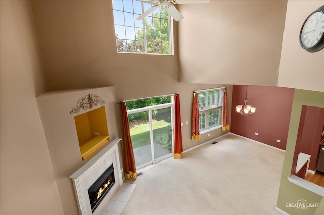 2823 White Thorn Cir, Naperville, IL 60564 - unfurnished living room featuring a towering ceiling, a chandelier, baseboards, a fireplace, and carpet flooring