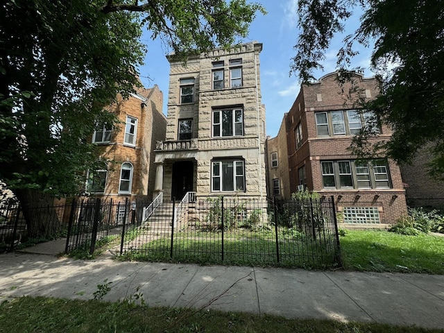 view of front of home featuring stone siding and a fenced front yard