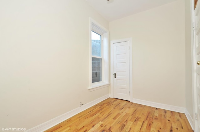 unfurnished room featuring light wood finished floors and baseboards