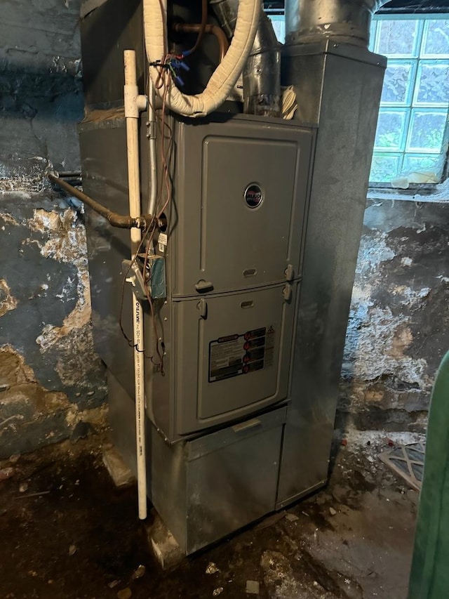 utility room featuring heating unit
