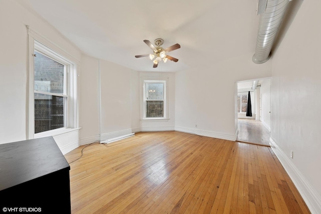 unfurnished living room with baseboards, light wood-style flooring, and a ceiling fan
