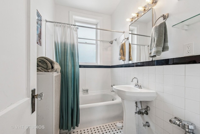 full bath featuring tile walls and shower / tub combo