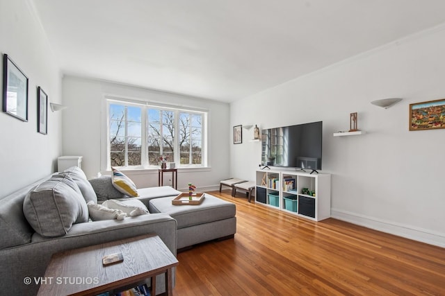 living area featuring baseboards and wood finished floors