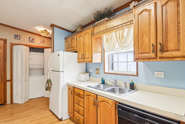 kitchen featuring a sink, light countertops, freestanding refrigerator, dishwashing machine, and ornamental molding