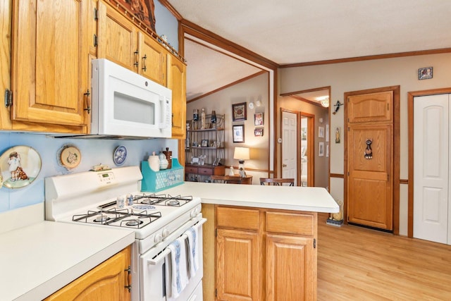 kitchen featuring a peninsula, light countertops, crown molding, and white appliances