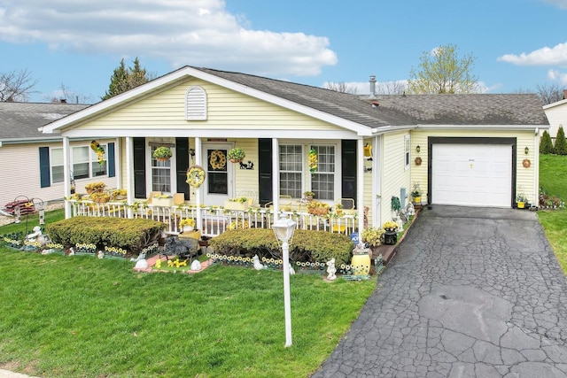 ranch-style house featuring a porch, a front lawn, and a garage