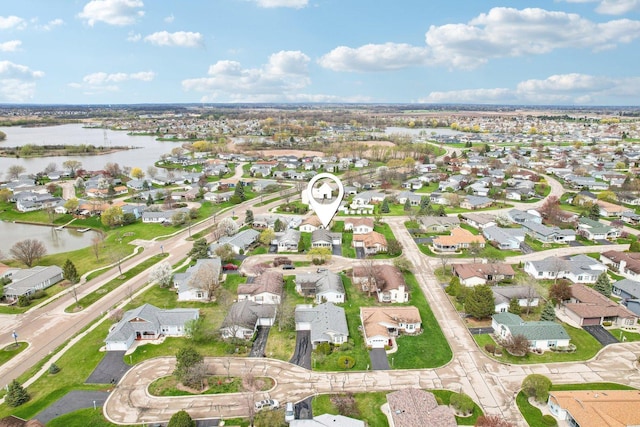 bird's eye view featuring a water view and a residential view