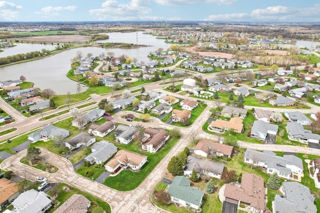 drone / aerial view featuring a water view and a residential view