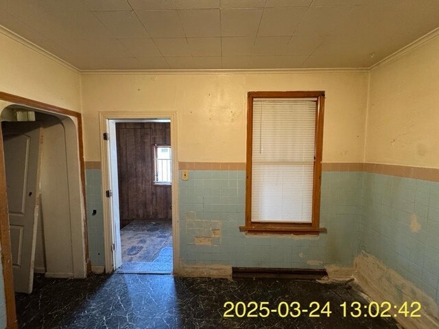 936 N Karlov Ave, Chicago, IL 60651 - bathroom featuring wainscoting, ornamental molding, and tile walls