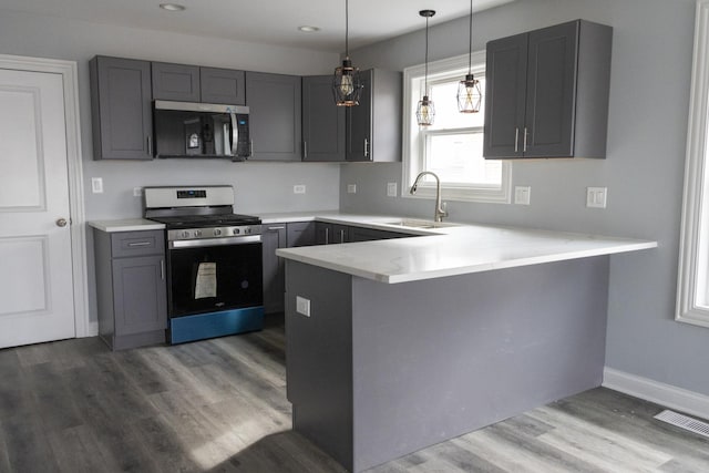 4147 Prairie St, Schiller Park, IL 60176 - kitchen with a sink, a peninsula, gray cabinetry, and stainless steel appliances