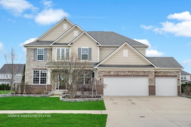 craftsman-style house featuring concrete driveway, stone siding, an attached garage, a front yard, and a shingled roof