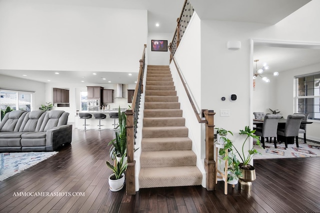 stairs featuring recessed lighting, wood-type flooring, and a wealth of natural light
