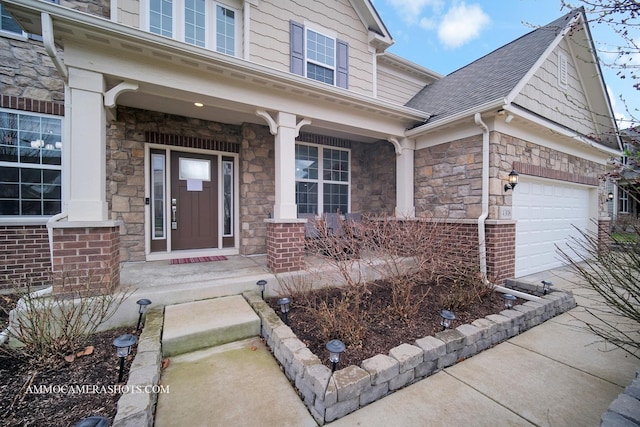 view of exterior entry with a porch, stone siding, and a shingled roof