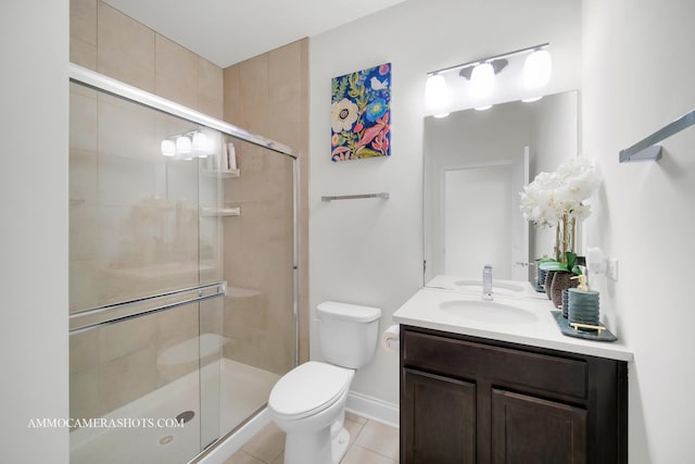 full bath with baseboards, toilet, vanity, tile patterned flooring, and a stall shower