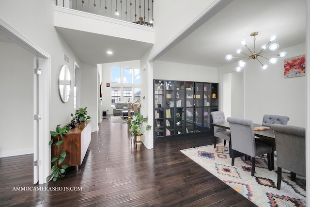 office featuring visible vents, baseboards, a notable chandelier, and wood finished floors