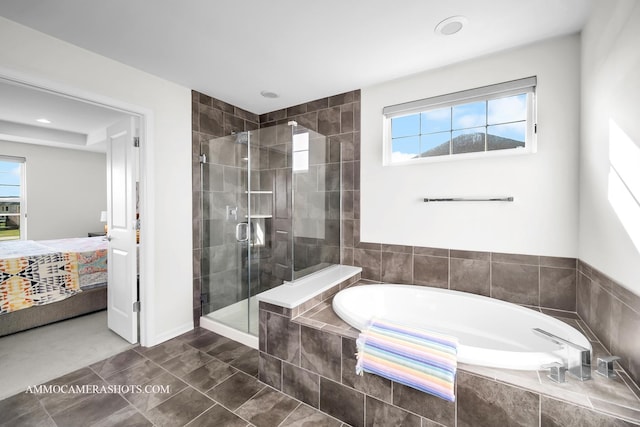 full bathroom with a bath, ensuite bathroom, a wealth of natural light, and a stall shower
