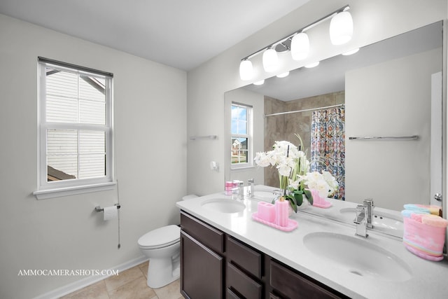 bathroom featuring a sink, a wealth of natural light, and toilet